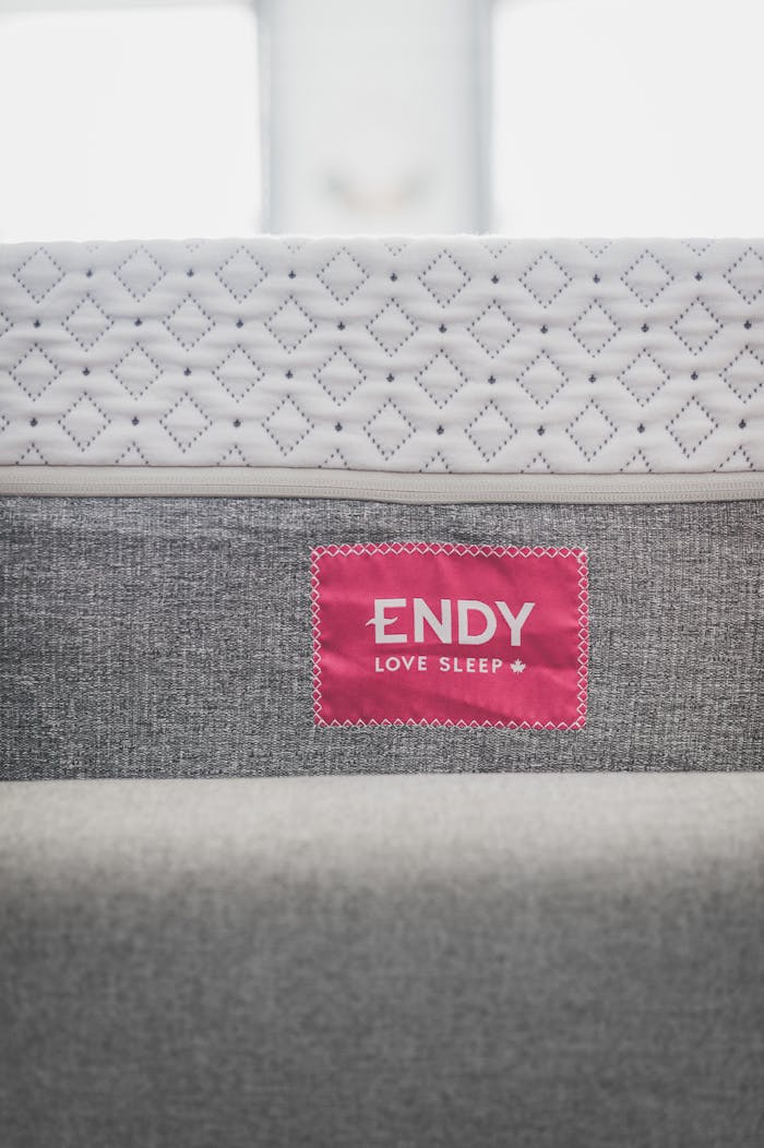 Close-up of modern Endy mattress with a pink tag, highlighting texture.
